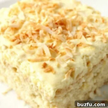 Pina Colada Dream Cake 3 Coconut Pineapple Cake piece on plate.