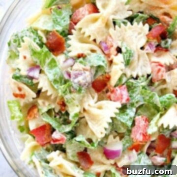 BLT Pasta Salad in large glass bowl, showcasing fresh ingredients and creamy dressing.