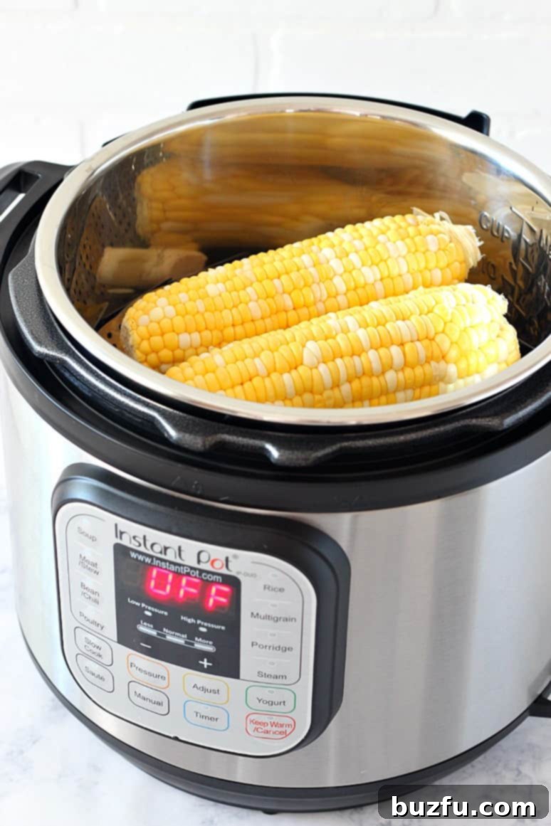 Side shot of corn on the cob placed inside Instant Pot on a trivet.
