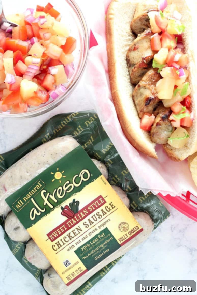 Vibrant Pineapple Salsa with fresh tomatoes, red onion, and bell pepper, ready to top a perfectly grilled chicken sausage.