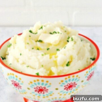 Instant Pot mashed potatoes in a bowl with red rim.