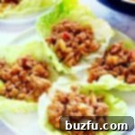 Homemade Chicken Lettuce Wraps arranged on a white plate.