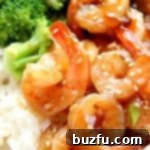 Teriyaki shrimp in a bowl with rice and broccoli.