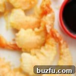 Crispy Shrimp Tempura arranged beautifully on a white plate.