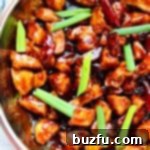 Chicken coated in rich Mongolian sauce in a pan.