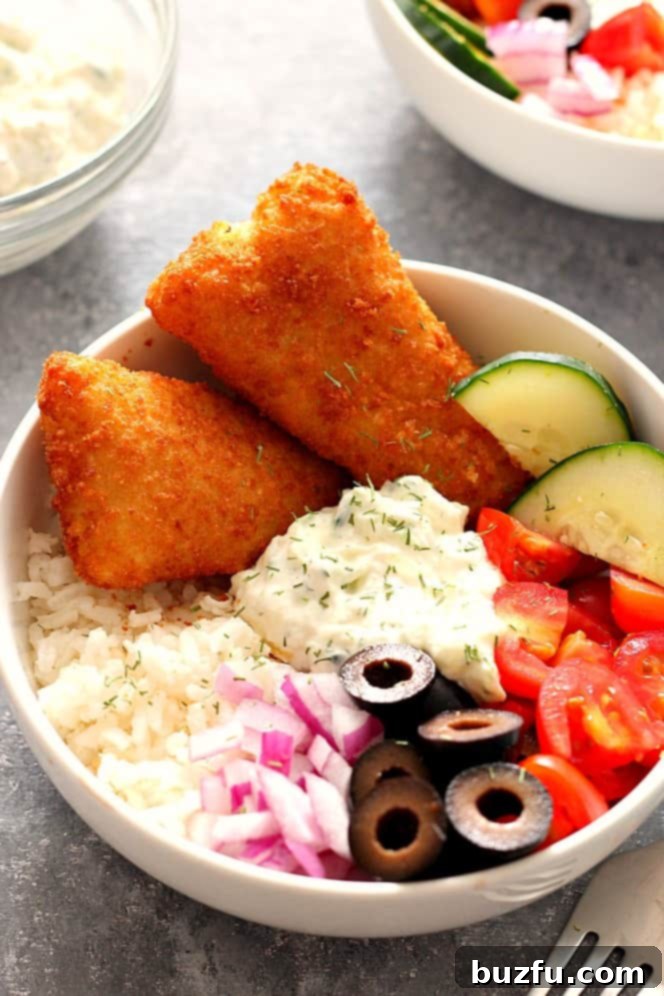 Crispy Fish Greek Rice Bowls Recipe - chopped vegetables, cucumber dill sauce and rice served with breaded fish fillets are a delicious lunch or dinner idea for busy weekdays.