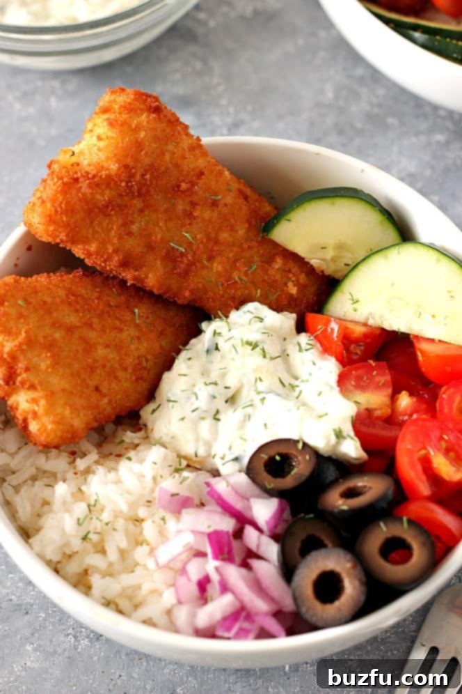 Crispy Fish Greek Rice Bowls Recipe - chopped vegetables, cucumber dill sauce and rice served with breaded fish fillets are a delicious lunch or dinner idea for busy weekdays.