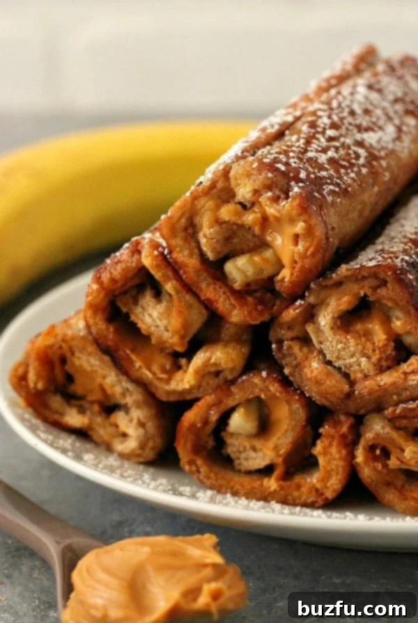 Delicious Peanut Butter Banana French Toast Roll Ups on a serving plate, dusted with powdered sugar.