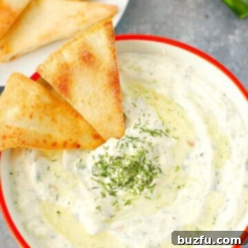 Effortless Homemade Tzatziki 3 Overhead shot of tzatziki sauce in bowl, with pita chips dipped. A perfect appetizer.