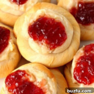 Sweet and Simple Cream Cheese Jam Danish 2 Cream Cheese Danish with strawberry jam on plate.