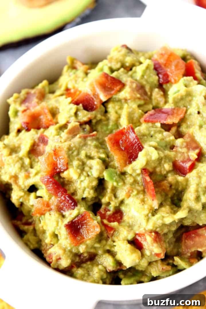 Delicious Bacon Guacamole Ready to Serve Close-up of bacon guacamole with tortilla chips.