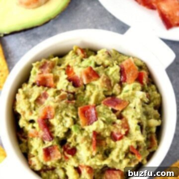 Smoky Guacamole with Crispy Bacon 2 Bacon guacamole in white serving bowl.