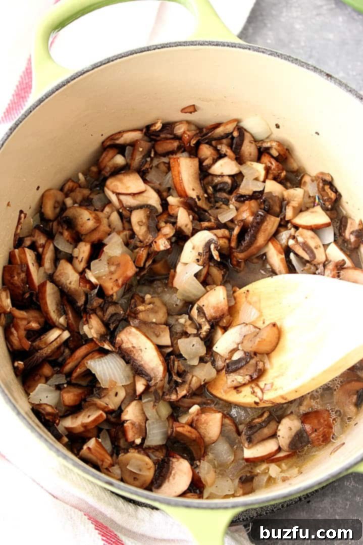 Craft Your Own Condensed Creamy Mushroom Soup 3 Sauteed mushrooms and onions in a green Dutch oven with a wooden spoon.