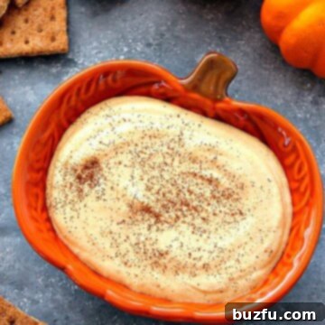 Creamy Spiced Pumpkin Cheesecake Dip 2 Pumpkin cheesecake dip in orange pumpkin bowl.