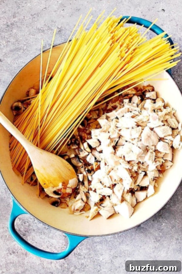 Essential ingredients for a delicious One Pot Turkey Tetrazzini, featuring fresh produce and pantry staples. Ingredients for One Pot Turkey Tetrazzini laid out in a skillet, ready for cooking.