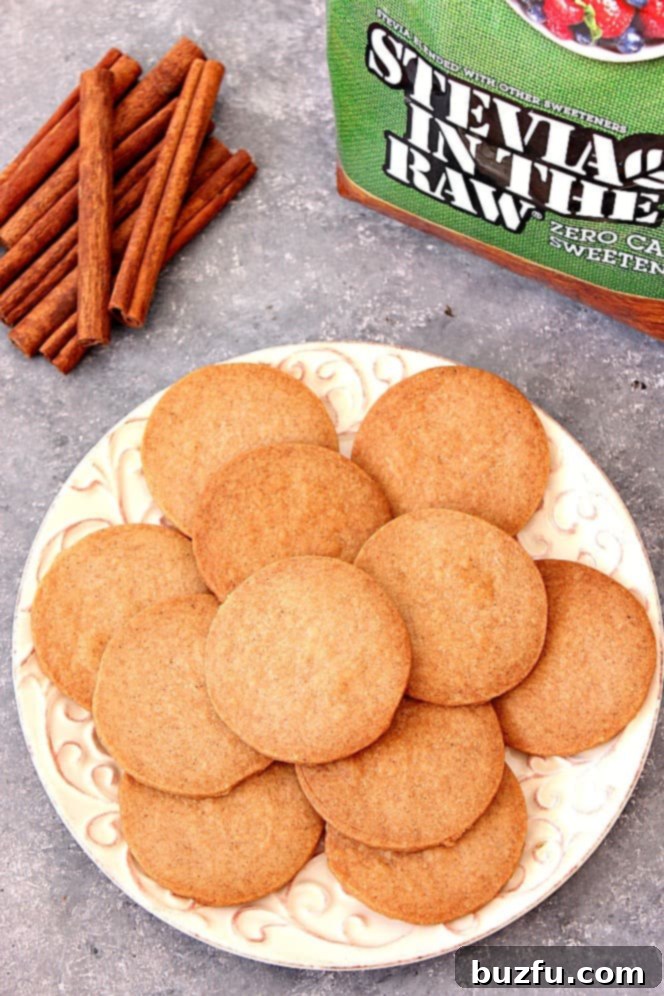Spiced shortbread cookies arranged on a white plate with decorative cinnamon sticks.