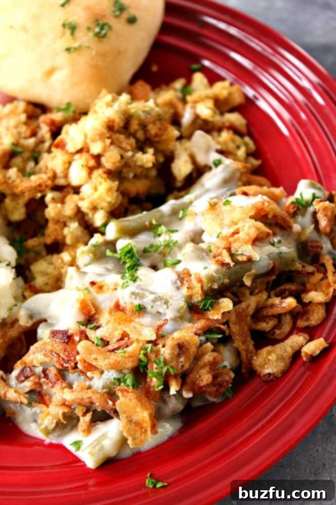Easy green bean casserole made in a slow cooker. Slow cooker green beans on a plate with stuffing.