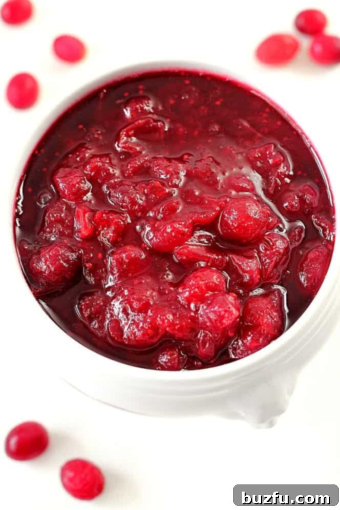 Homemade Cranberry sauce in a white serving dish, ready to be enjoyed.