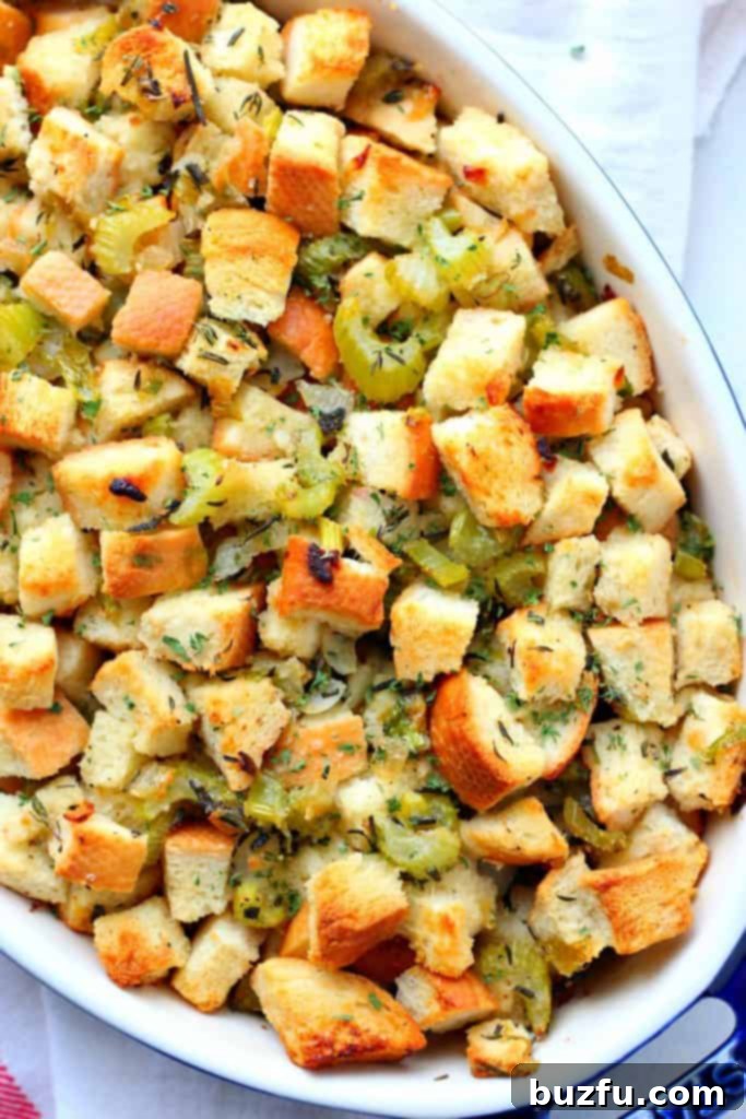Golden-brown classic stuffing baked in a rectangular ceramic baking dish, ready to be served.