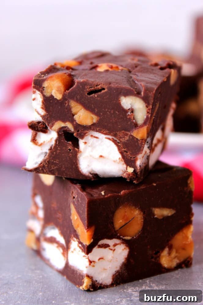Rocky Road Fudge made with just 4 ingredients. Rocky Road Fudge squares on a board.