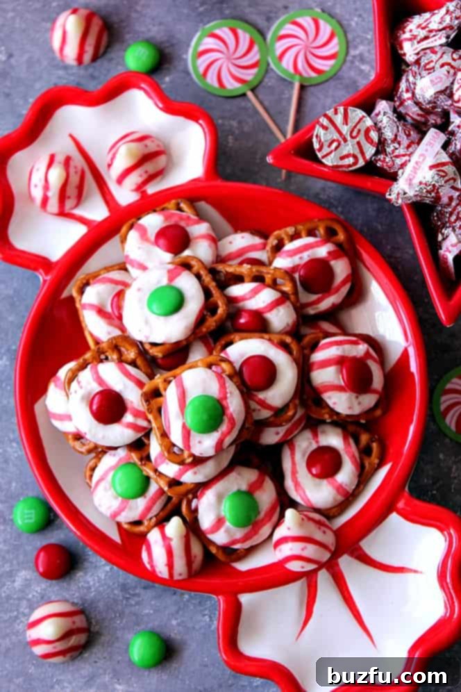 Peppermint Pretzel Candy: Easy Holiday Treat Peppermint Pretzel Candy recipe - crunchy pretzels topped with peppermint Kisses candy and M&M's makes for a festive holiday treat that is fun to make and eat!