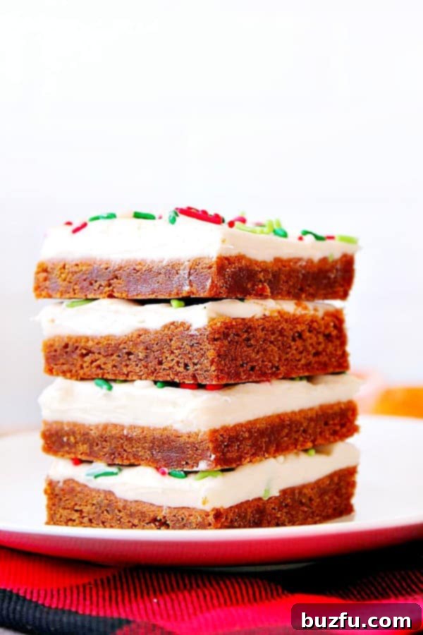 Stack of gingerbread bars with frosting.