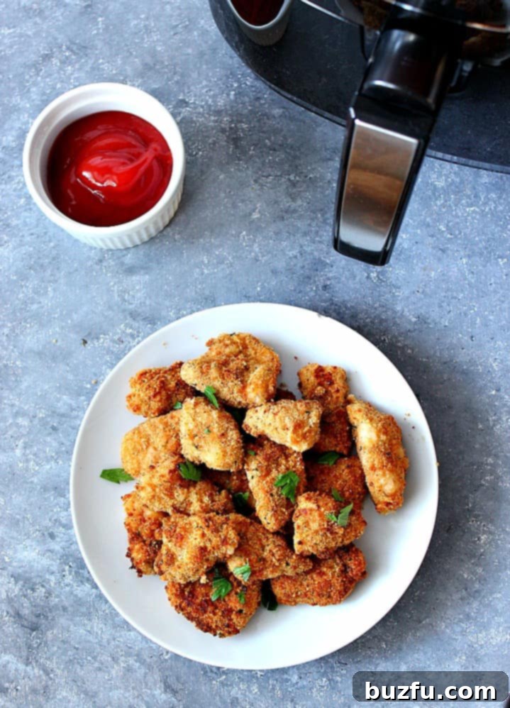 Deliciously Crispy Air Fryer Chicken Nuggets Close-up of golden-brown Air Fryer Chicken Nuggets piled high on a plate, ready to be served. Highlighting the perfectly crispy coating achieved with air frying.