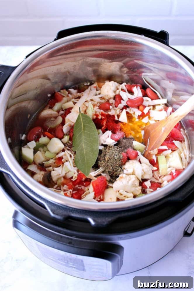 Instant Pot filled with all the vibrant ingredients for a healthy weight loss vegetable soup, before cooking.