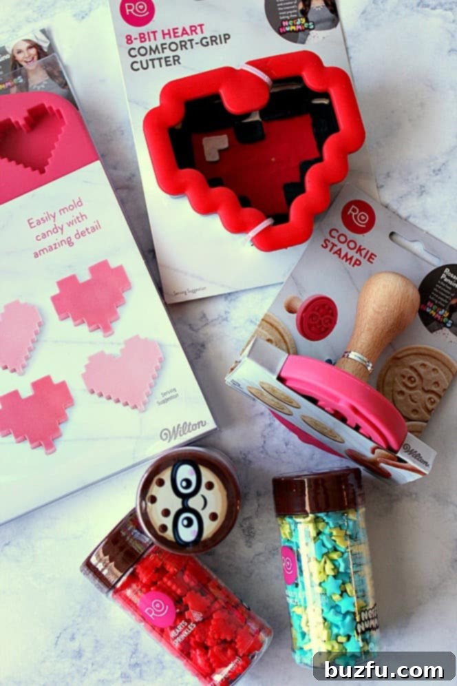 A set of colorful Nerdy Nummies baking tools, including an 8-bit heart cookie cutter, candy mold, cookie stamp, and sprinkles.