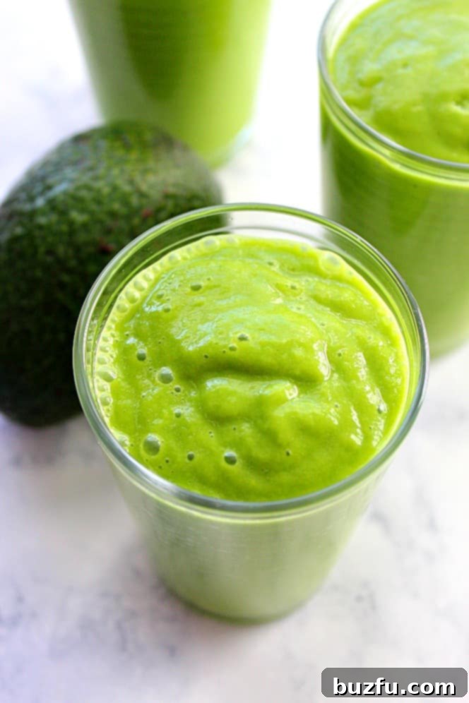 Avocado Glow Smoothie: A perfect, healthy, and delicious green smoothie in a glass. A single glass of Avocado Glow Smoothie, perfectly blended and ready to drink, with a focus on its appealing green color and smooth texture.