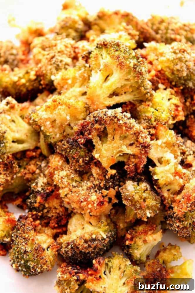 Close-up of golden brown, crunchy garlic parmesan roasted broccoli served on a plate.