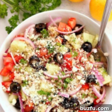 A perfectly prepared bowl of Greek Salad with Barley, showcasing its vibrant ingredients and inviting texture, ready to be served.
