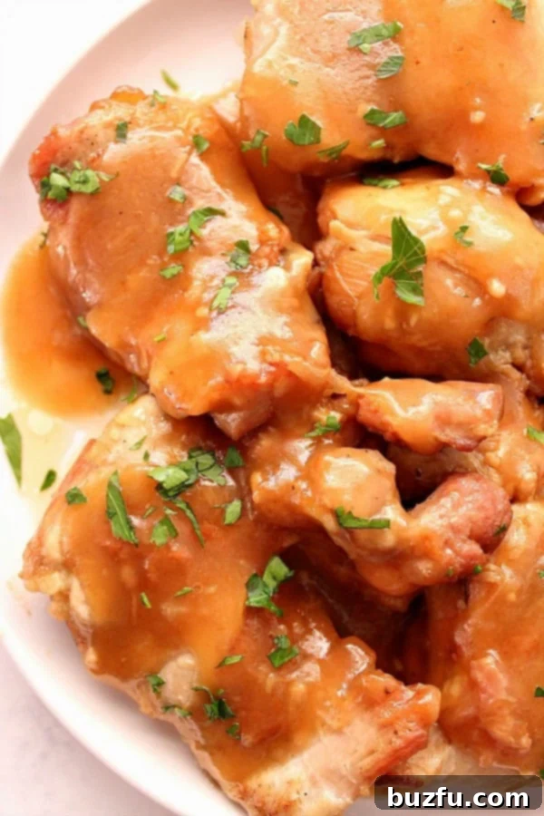A tantalizing plate of Instant Pot Sweet Garlic Chicken, coated in a rich brown sugar garlic sauce, served with a side dish.