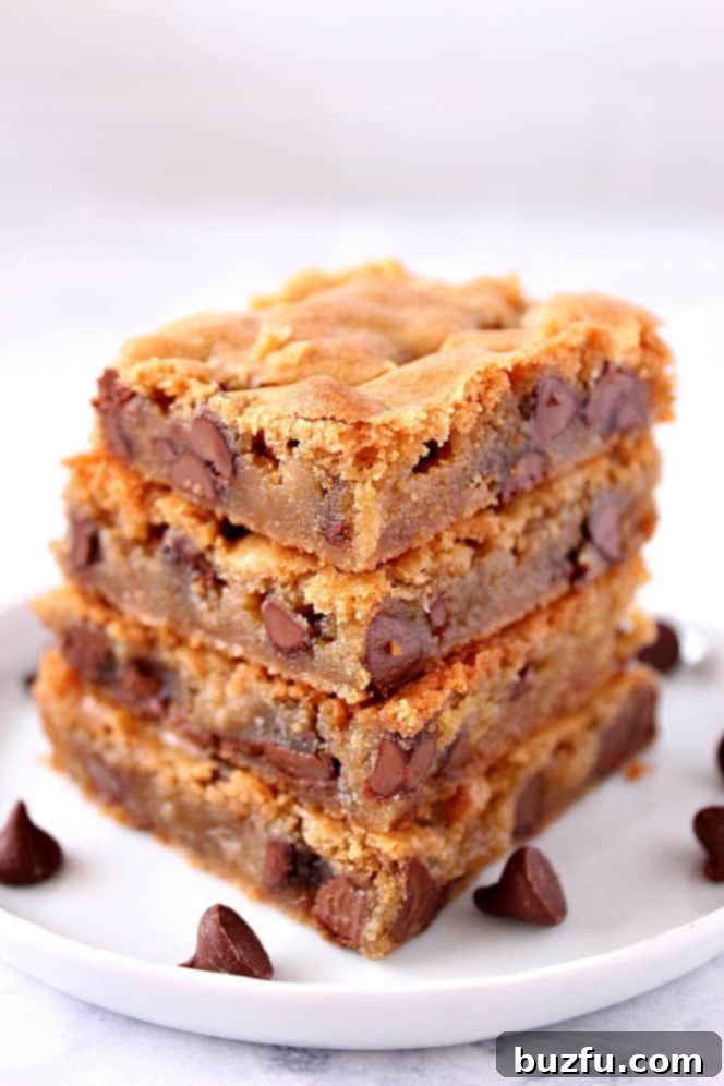 Stack of golden chocolate chip blondie bars, showcasing their gooey texture
