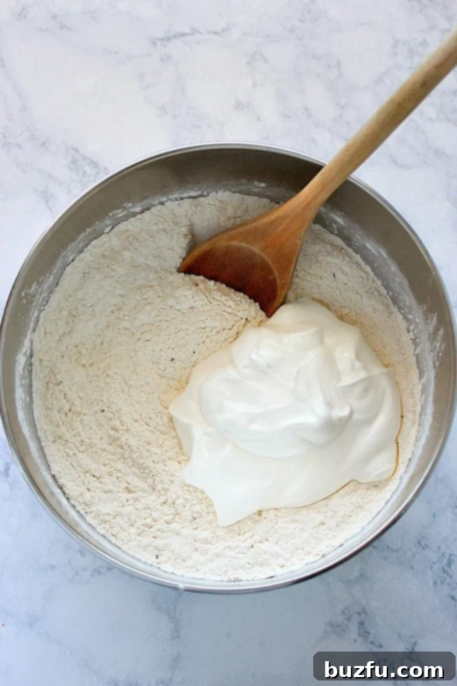 A mixing bowl with flour and sour cream, the two key ingredients for quick pizza dough.