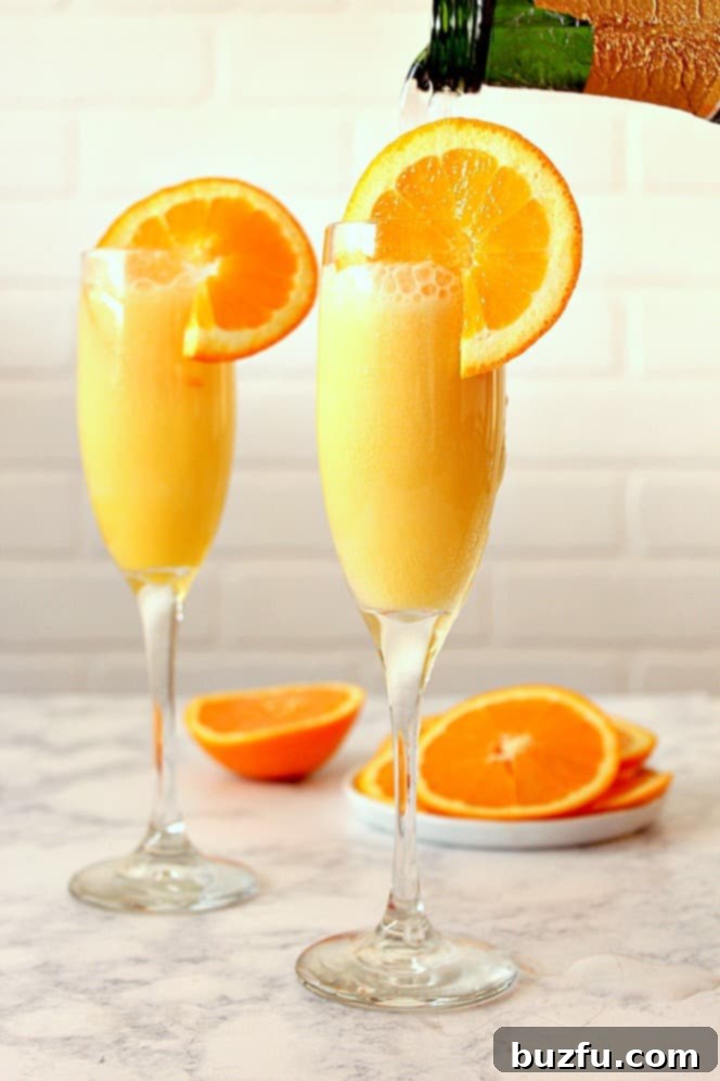 pouring champagne into flute with orange juice and slices