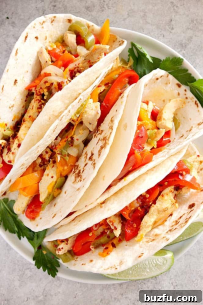 Flavorful Instant Pot chicken fajitas served on a plate with fresh lime and cilantro.