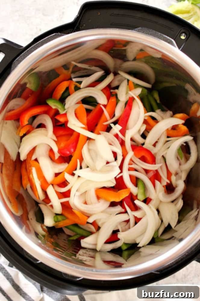 Sliced bell peppers and onion ready to be cooked in the Instant Pot.