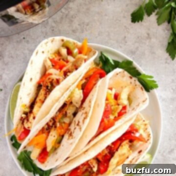 Instant Pot Chicken Fajitas on a white plate, ready to serve.