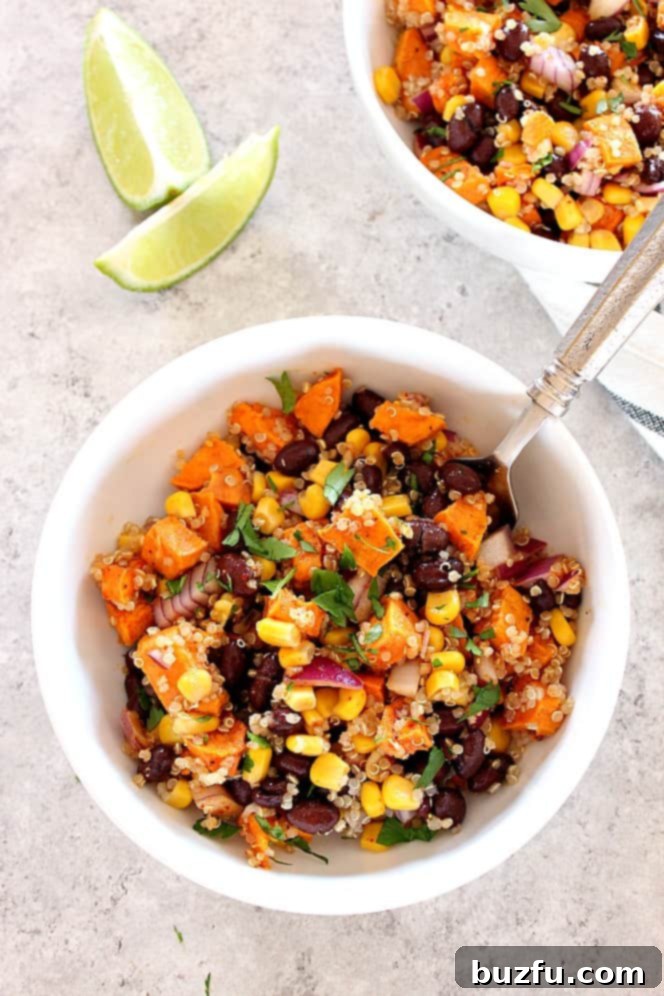 sweet potato quinoa salad in two bowls with lime wedges