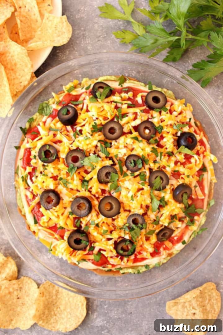 Mexican dip with olives and cheese in a serving platter