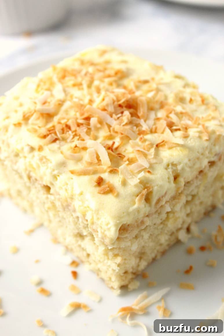 slice of pineapple cake with coconut frosting on a plate