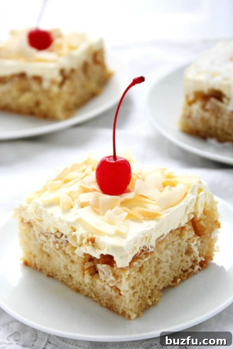 cake with coconut frosting and cherry on plate