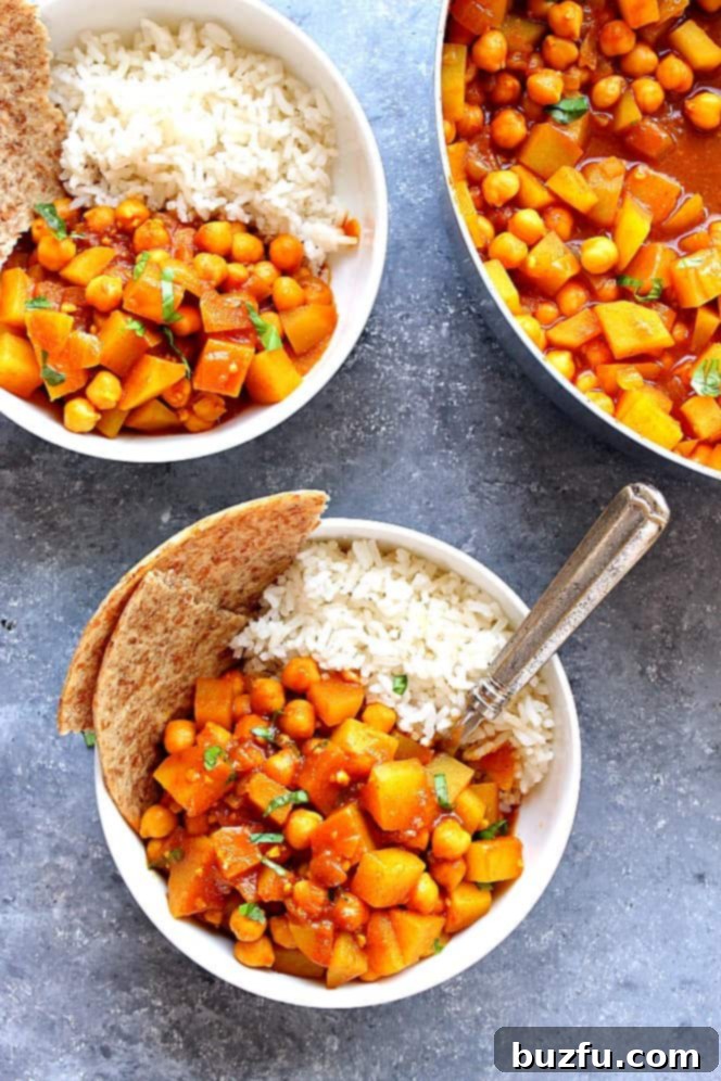 Two bowls of Easy Chickpea and Potato Curry served with fresh cilantro garnish