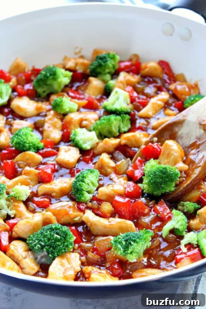 Side view of a skillet brimming with colorful Teriyaki Chicken Stir Fry, featuring perfectly cooked chicken and bright green broccoli florets.