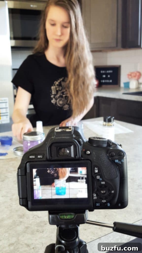 A candid behind-the-scenes shot of a camera lens focused on a vibrant craft project, highlighting the creative process.