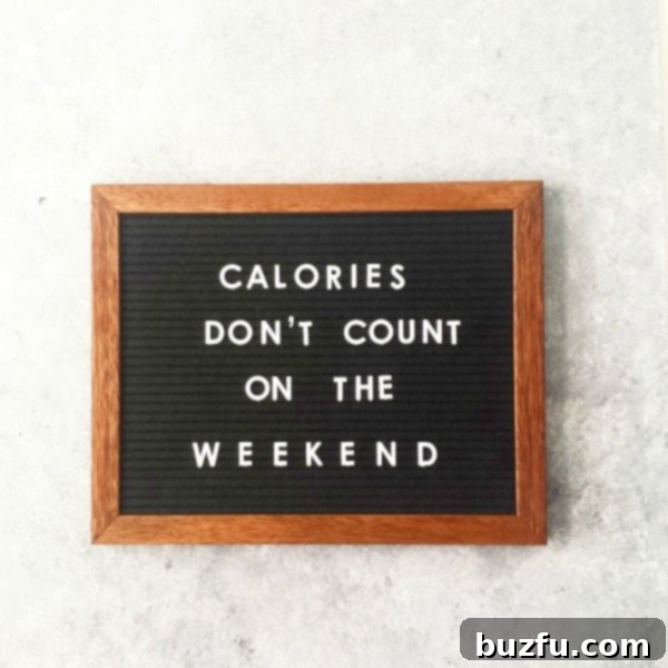 A charming letterboard displaying the witty phrase 'Calories don't count on the weekend,' surrounded by seasonal decor.