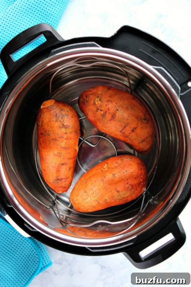 Effortless Instant Pot Sweet Potatoes 3 Overhead shot of Instant Pot with three sweet potatoes on trivet.