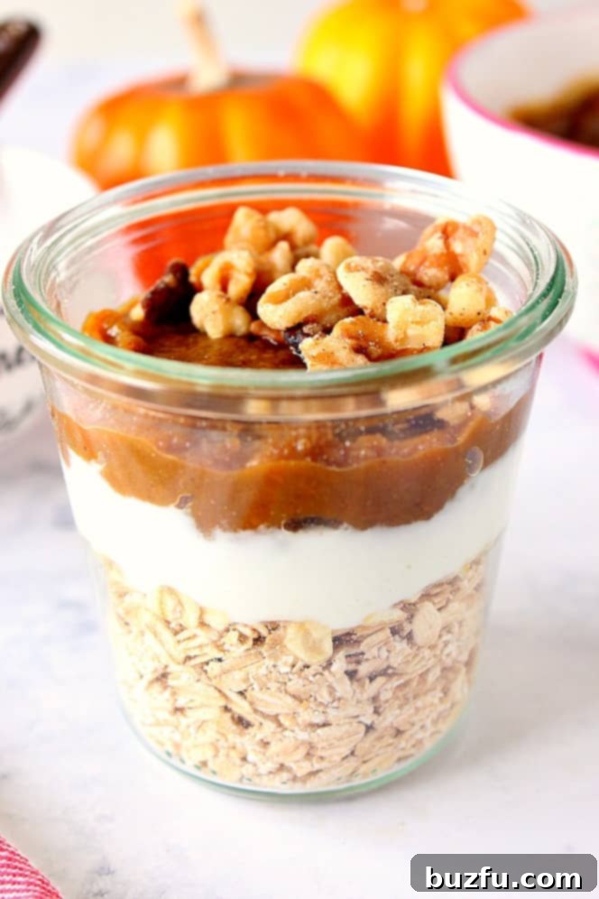 Side shot of Pumpkin Overnight Oats in a glass jar, showing layers and texture.