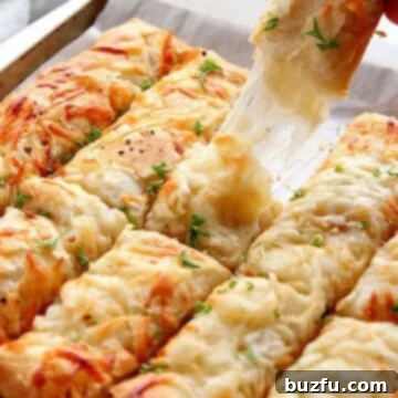 Cheesy breadsticks on a baking sheet.